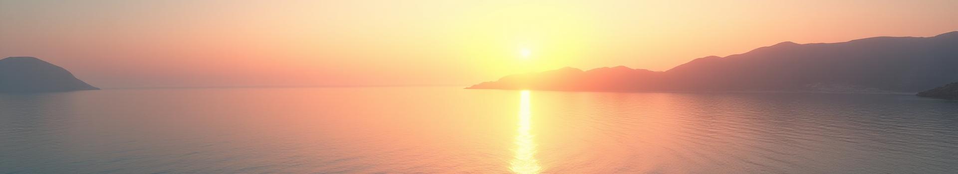 Vista panoramica di un'alba serena sulla costa mediterranea, con colori caldi che suggeriscono rinnovamento e nuove energie.